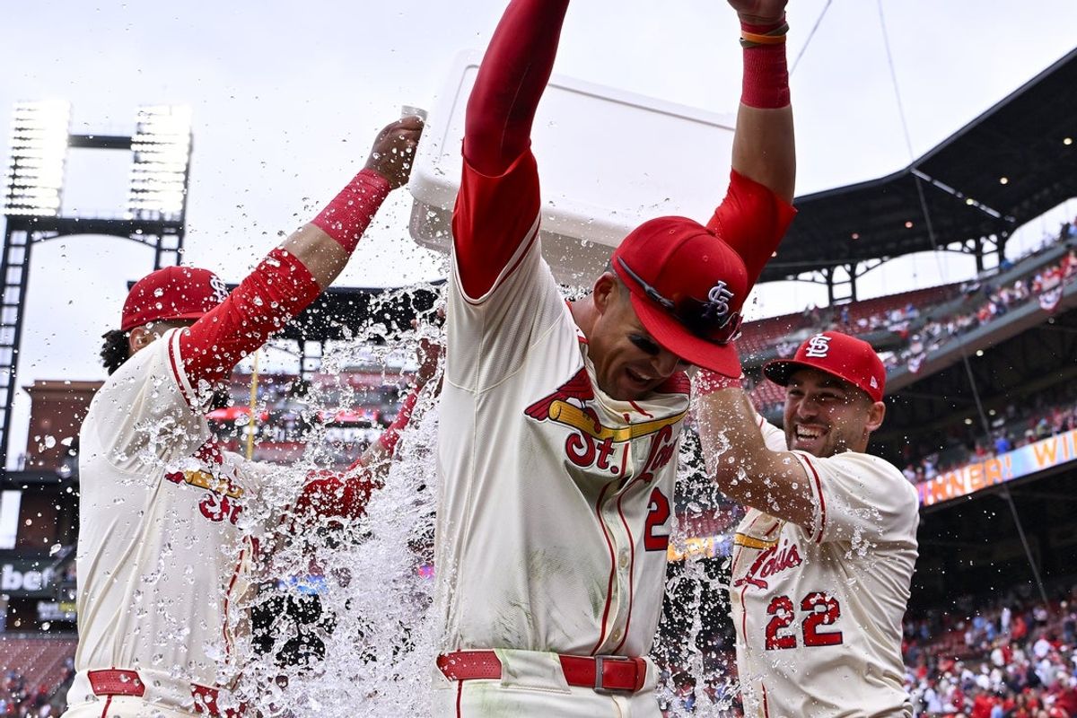 Mar 29, 2025; St. Louis, Missouri, USA;  St. Louis Cardinals left fielder Lars Nootbaar (21) is doused with water by shortstop Masyn Winn (0) and center fielder Michael Siani (22) after the Cardinals defeated the Minnesota Twins at Busch Stadium. Mandatory Credit: Jeff Curry-Imagn Images