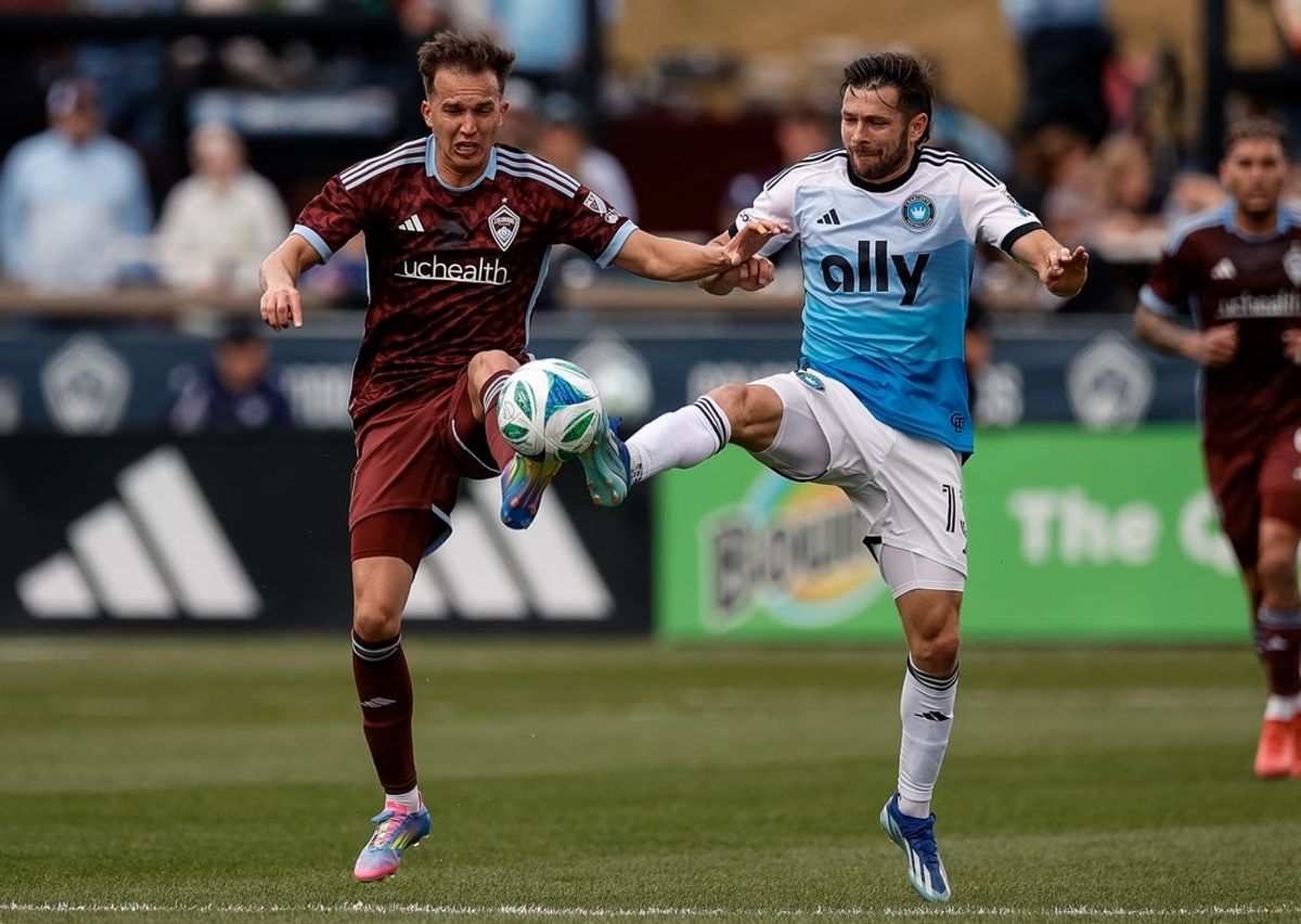 Mar 29, 2025; Commerce City, Colorado, USA; Colorado Rapids midfielder Cole Bassett (23) and Charlotte FC midfielder Brandt Bronico (13) battle for the ball in the first half at Dick's Sporting Goods Park. Mandatory Credit: Isaiah J. Downing-Imagn Images