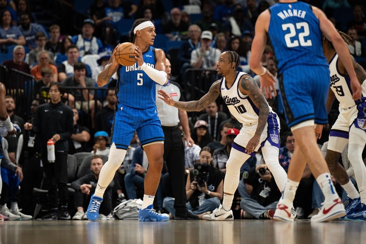 Mar 29, 2025; Orlando, Florida, USA; Orlando Magic forward Paolo Banchero (5) passes the ball against Sacramento Kings guard/forward DeMar DeRozan (10) in the first quarter at Kia Center. Mandatory Credit: Jeremy Reper-Imagn Images