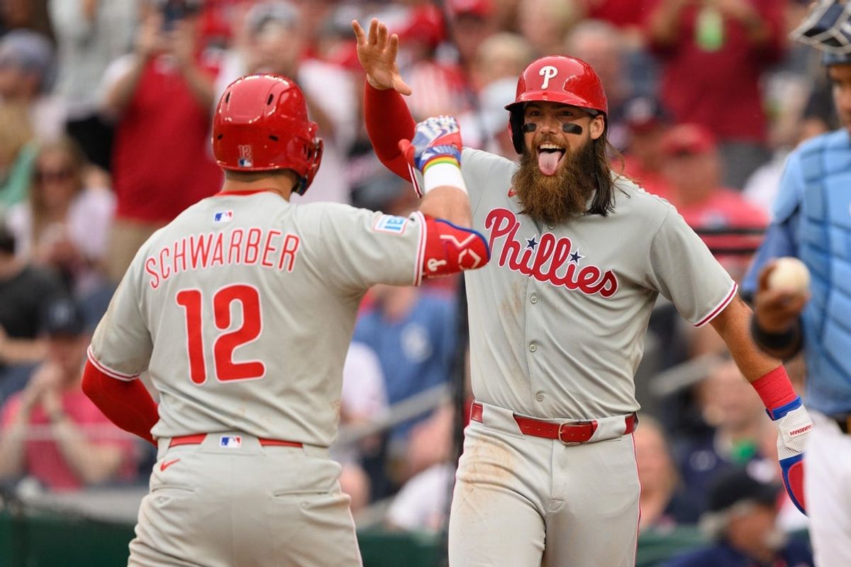 Mar 29, 2025; Washington, District of Columbia, USA; Philadelphia Phillies outfielder Brandon Marsh (16) celebrates with after designated hitter Kyle Schwarber (12) hits a three run home run during the sixth inning at Nationals Park. Mandatory Credit: Reggie Hildred-Imagn Images