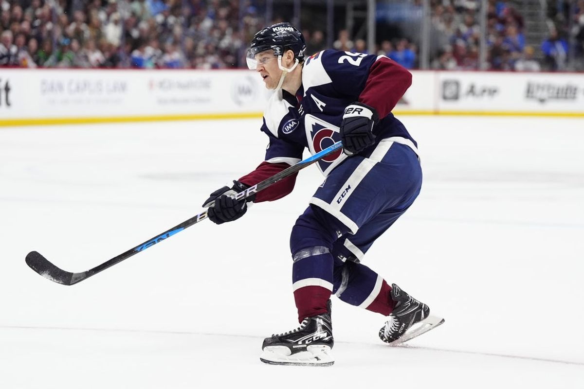 Mar 29, 2025; Denver, Colorado, USA; Colorado Avalanche center Nathan MacKinnon (29) takes a shot on net in the second period against the St. Louis Blues at Ball Arena. Mandatory Credit: Ron Chenoy-Imagn Images