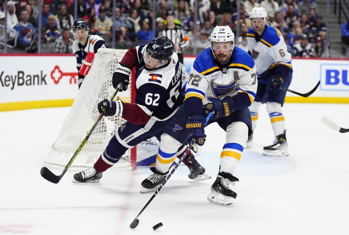 Mar 29, 2025; Denver, Colorado, USA; St. Louis Blues defenseman Justin Faulk (72) and Colorado Avalanche left wing Artturi Lehkonen (62) battle for the puck in the second period at Ball Arena. Mandatory Credit: Ron Chenoy-Imagn Images