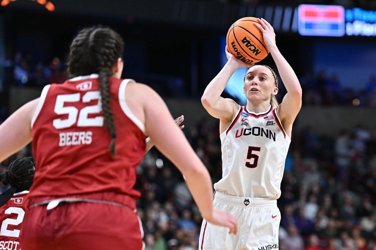 Mar 29, 2025; Spokane, WA, USA; UConn Huskies guard Paige Bueckers (5) shoots against Oklahoma Sooners guard Reyna Scott (2) during the second half of a Sweet 16 NCAA Tournament basketball game at Spokane Arena. Mandatory Credit: James Snook-Imagn Images