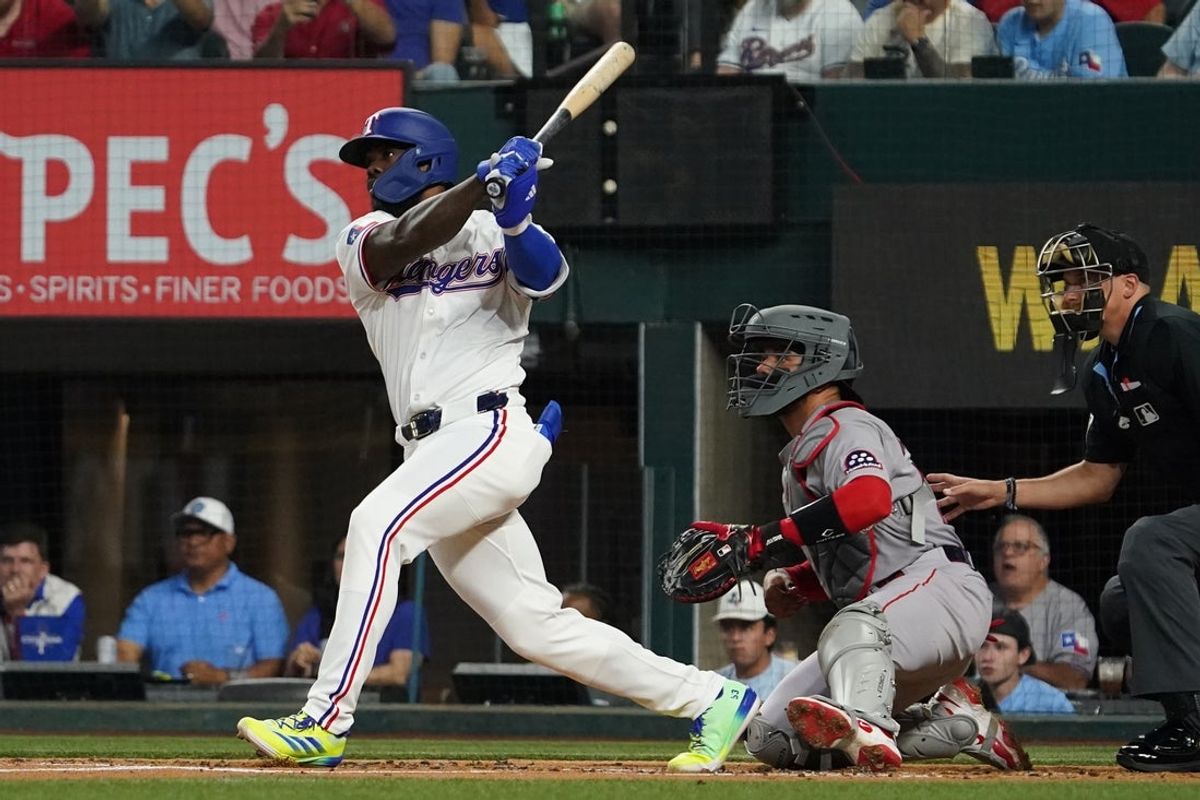 Mar 29, 2025; Arlington, Texas, USA; Texas Rangers outfielder Adolis Garcia (53) hits a two-run double during the first inning against the Boston Red Sox at Globe Life Field. Mandatory Credit: Raymond Carlin III-Imagn Images