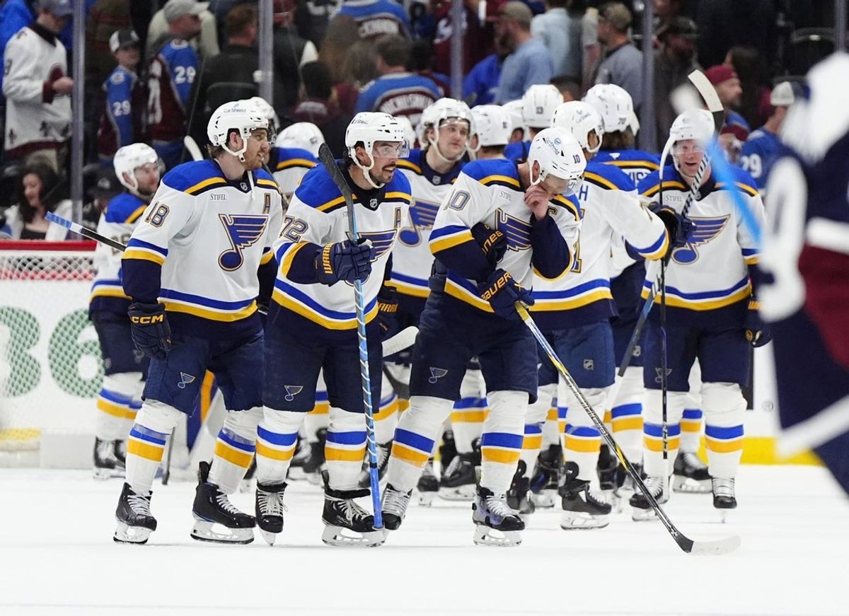 Mar 29, 2025; Denver, Colorado, USA; Members of the St. Louis Blues celebrate defeating the Colorado Avalanche at Ball Arena. Mandatory Credit: Ron Chenoy-Imagn Images