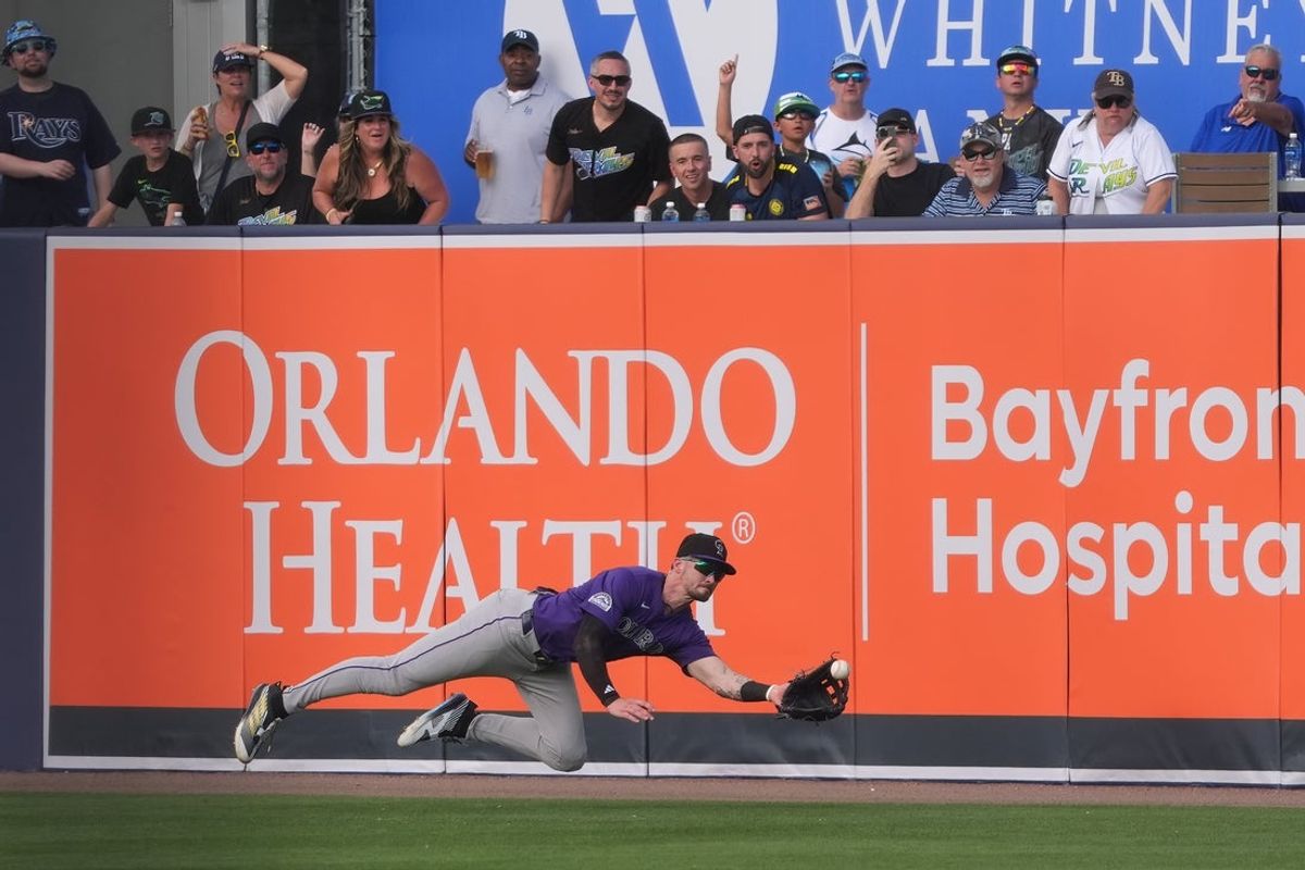 Mar 29, 2025; Tampa, Florida, USA; Colorado Rockies outfielder Brenton Doyle (9) catches a ball hit by Tampa Bay Rays first base Yandy Diaz (2) during the fifth inning at George M. Steinbrenner Field. Mandatory Credit: Dave Nelson-Imagn Images