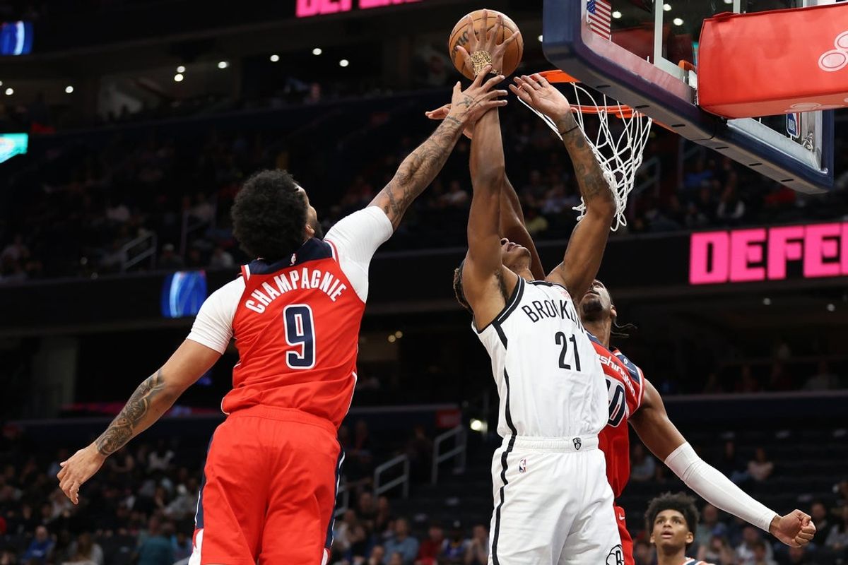 Mar 29, 2025; Washington, District of Columbia, USA; Washington Wizards forward Alex Sarr (20) swats the ball away from Brooklyn Nets forward Noah Clowney (21) during the first half at Capital One Arena. Mandatory Credit: Daniel Kucin Jr.-Imagn Images