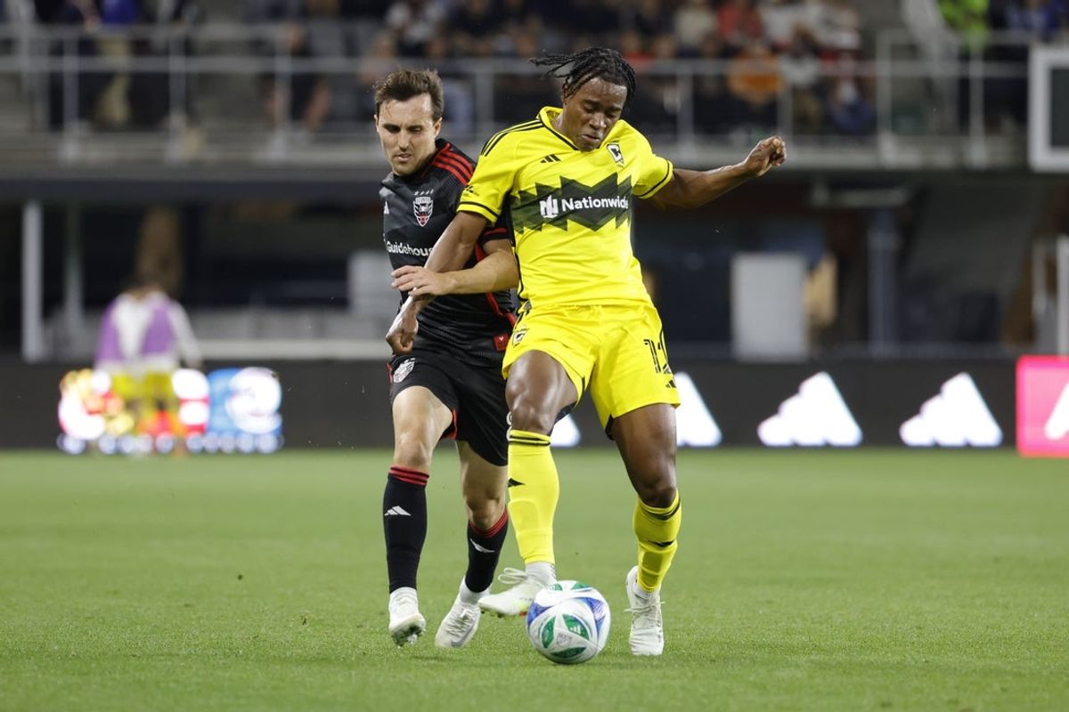 Mar 29, 2025; Washington, District of Columbia, USA; D.C. United midfielder Jared Stroud (8) battles for the ball with Columbus Crew forward DeJuan Jones (12) during the first half at Audi Field. Mandatory Credit: Amber Searls-Imagn Images
