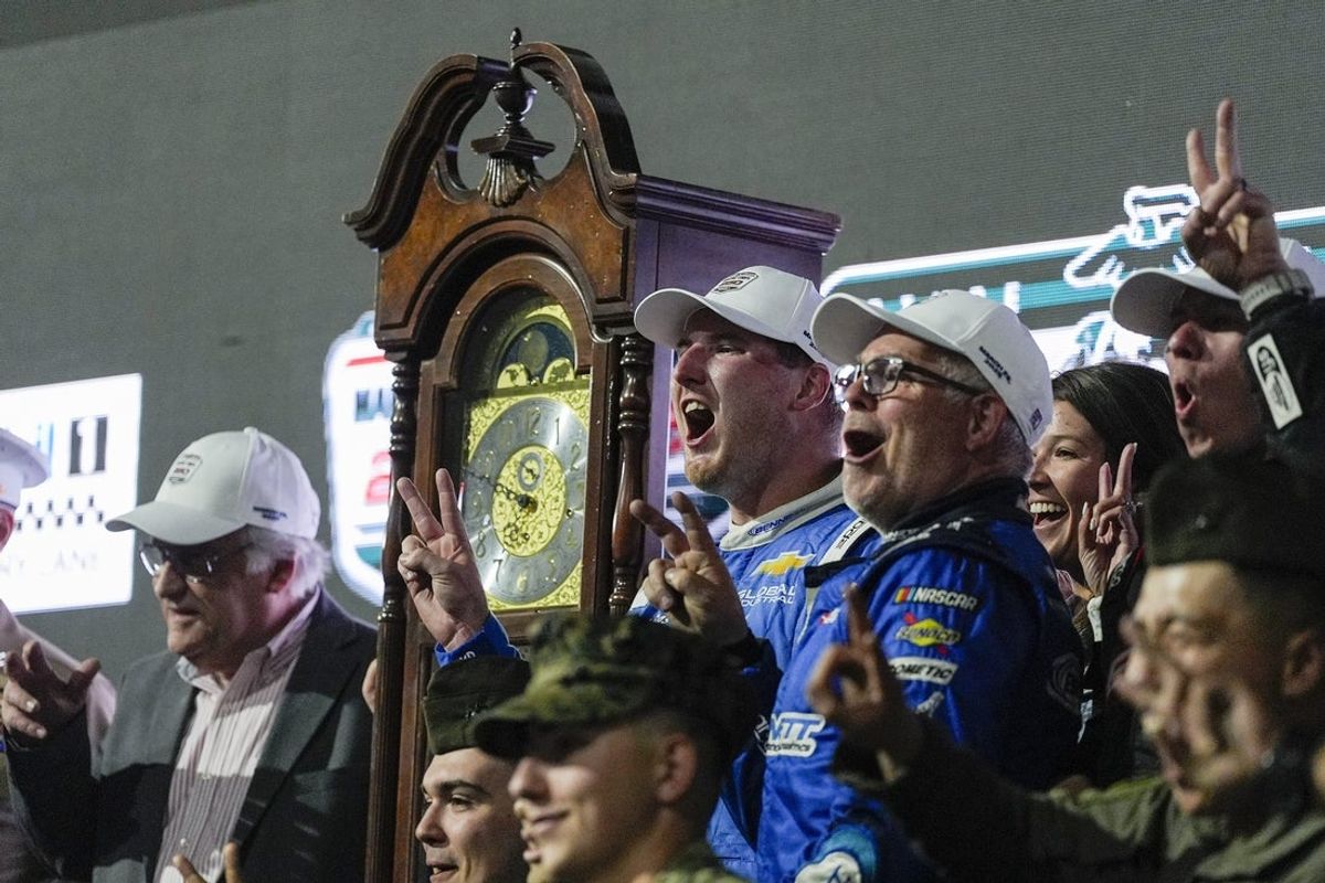 Mar 29, 2025; Martinsville, Virginia, USA; NASCAR Xfinity Series driver Austin Hill (21) wins the clock trophy during the Marine Corp 250 at Martinsville Speedway. Mandatory Credit: Jim Dedmon-Imagn Images