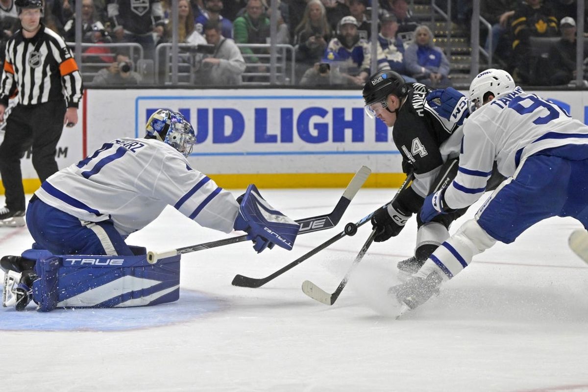 Mar 29, 2025; Los Angeles, California, USA;  Toronto Maple Leafs goaltender Anthony Stolarz (41) makes a save off a shot on goal by Los Angeles Kings defenseman Mikey Anderson (44) as Toronto Maple Leafs center John Tavares (91) defends during the second period at Crypto.com Arena. Mandatory Credit: Jayne Kamin-Oncea-Imagn Images