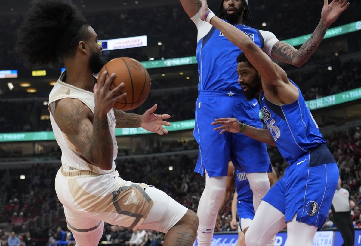 Mar 29, 2025; Chicago, Illinois, USA; Dallas Mavericks guard Spencer Dinwiddie (26) defends Chicago Bulls guard Coby White (0) during the first half at United Center. Mandatory Credit: David Banks-Imagn Images