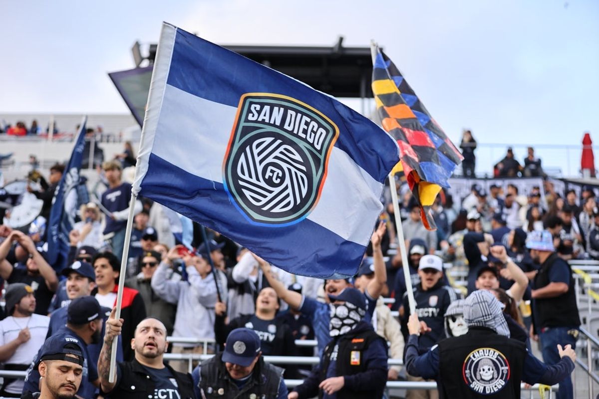 Mar 29, 2025; San Diego, California, USA;  San Diego FC fans raise flags before match against Los Angeles FC at Snapdragon Stadium. Mandatory Credit: Julia Kapros-Imagn Images