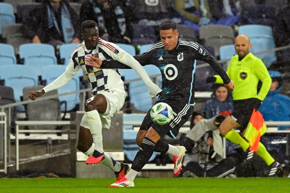 Mar 29, 2025; Saint Paul, Minnesota, USA;  Real Salt Lake forward Forster Ajago (27) and Minnesota United defender Nicolas Romero (5) battle for the ball during the first half at Allianz Field. Mandatory Credit: Nick Wosika-Imagn Images