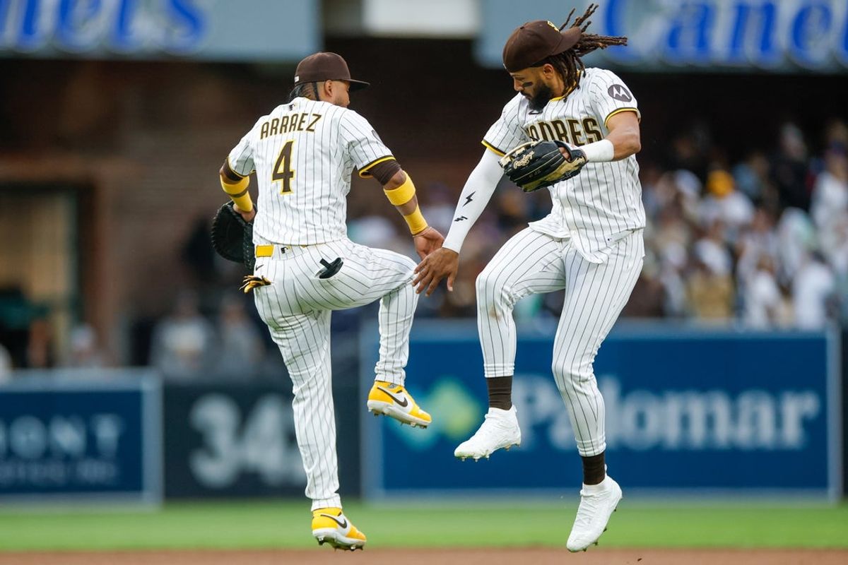 Mar 29, 2025; San Diego, California, USA; San Diego Padres first baseman Luis Arraez (4) celebrates with San Diego Padres right fielder Fernando Tatis Jr. (23) after a victory over the Atlanta Braves at Petco Park. Mandatory Credit: David Frerker-Imagn Images