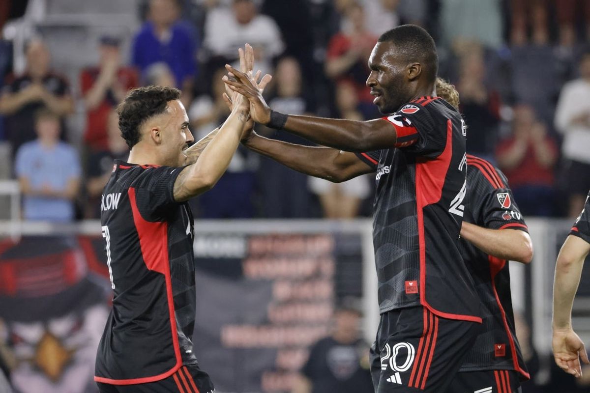 Mar 29, 2025; Washington, District of Columbia, USA; D.C. United forward Christian Benteke (20) celebrates with United forward Joao Peglow (7) after scoring a goal against Columbus Crew during the first half at Audi Field. Mandatory Credit: Amber Searls-Imagn Images