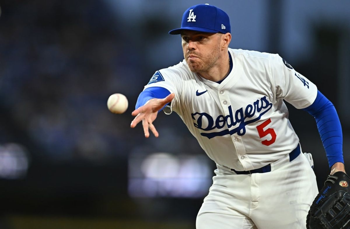 Mar 29, 2025; Los Angeles, California, USA; Los Angeles Dodgers first baseman Freddie Freeman (5) tosses to first for an out during the 3rd inning against the Detroit Tigers at Dodger Stadium. Mandatory Credit: Jonathan Hui-Imagn Images