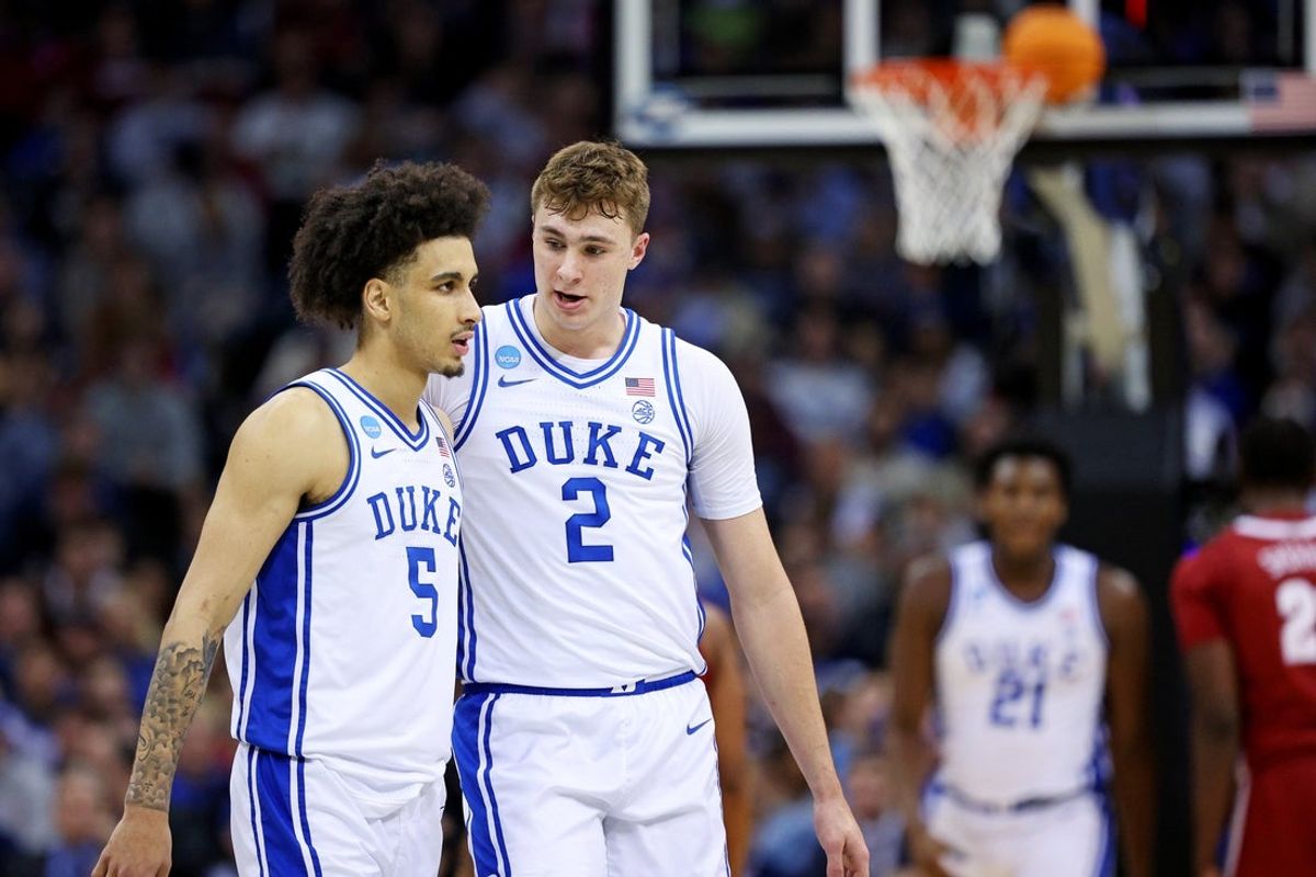Mar 29, 2025; Newark, NJ, USA; Duke Blue Devils guard Tyrese Proctor (5) talks with forward Cooper Flagg (2) during the second half against the Alabama Crimson Tide in the East Regional final of the 2025 NCAA tournament at Prudential Center. Mandatory Credit: Vincent Carchietta-Imagn Images