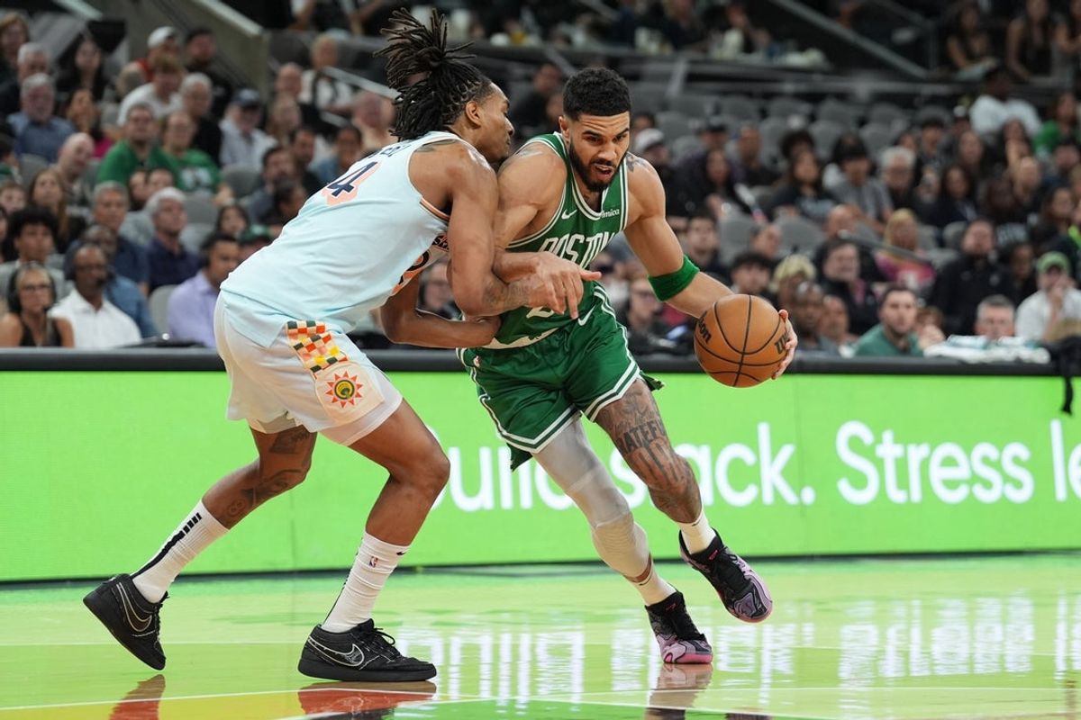 Mar 29, 2025; San Antonio, Texas, USA;  Boston Celtics forward Jayson Tatum (0) dribbles against San Antonio Spurs guard Devin Vassell (24) in the second half at Frost Bank Center. Mandatory Credit: Daniel Dunn-Imagn Images