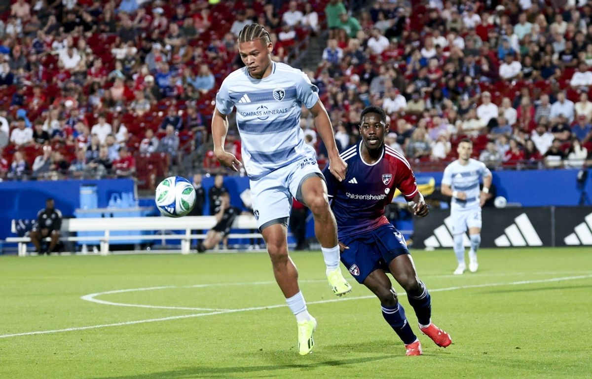 Mar 29, 2025; Frisco, Texas, USA;  Sporting Kansas City defender Zorhan Bassong (22) controls the ball as FC Dallas defender Osaze Urhoghide (3) defends during the second half at Toyota Stadium. Mandatory Credit: Kevin Jairaj-Imagn Images