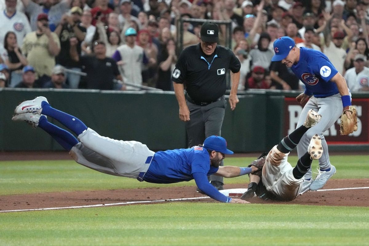Mar 29, 2025; Phoenix, Arizona, USA; Chicago Cubs shortstop Dansby Swanson (7) tags out Arizona Diamondbacks outfielder Garrett Hampson (8) at thirdbase to end the game in the ninth inning at Chase Field. Mandatory Credit: Rick Scuteri-Imagn Images