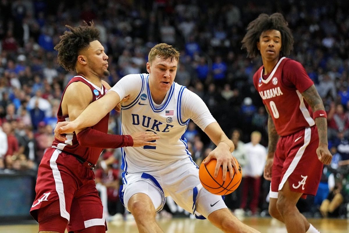 Mar 29, 2025; Newark, NJ, USA; Duke Blue Devils forward Cooper Flagg (2) drives to the basket against Alabama Crimson Tide guard Mark Sears (1) during the second half in the East Regional final of the 2025 NCAA tournament at Prudential Center. Mandatory Credit: Robert Deutsch-Imagn Images