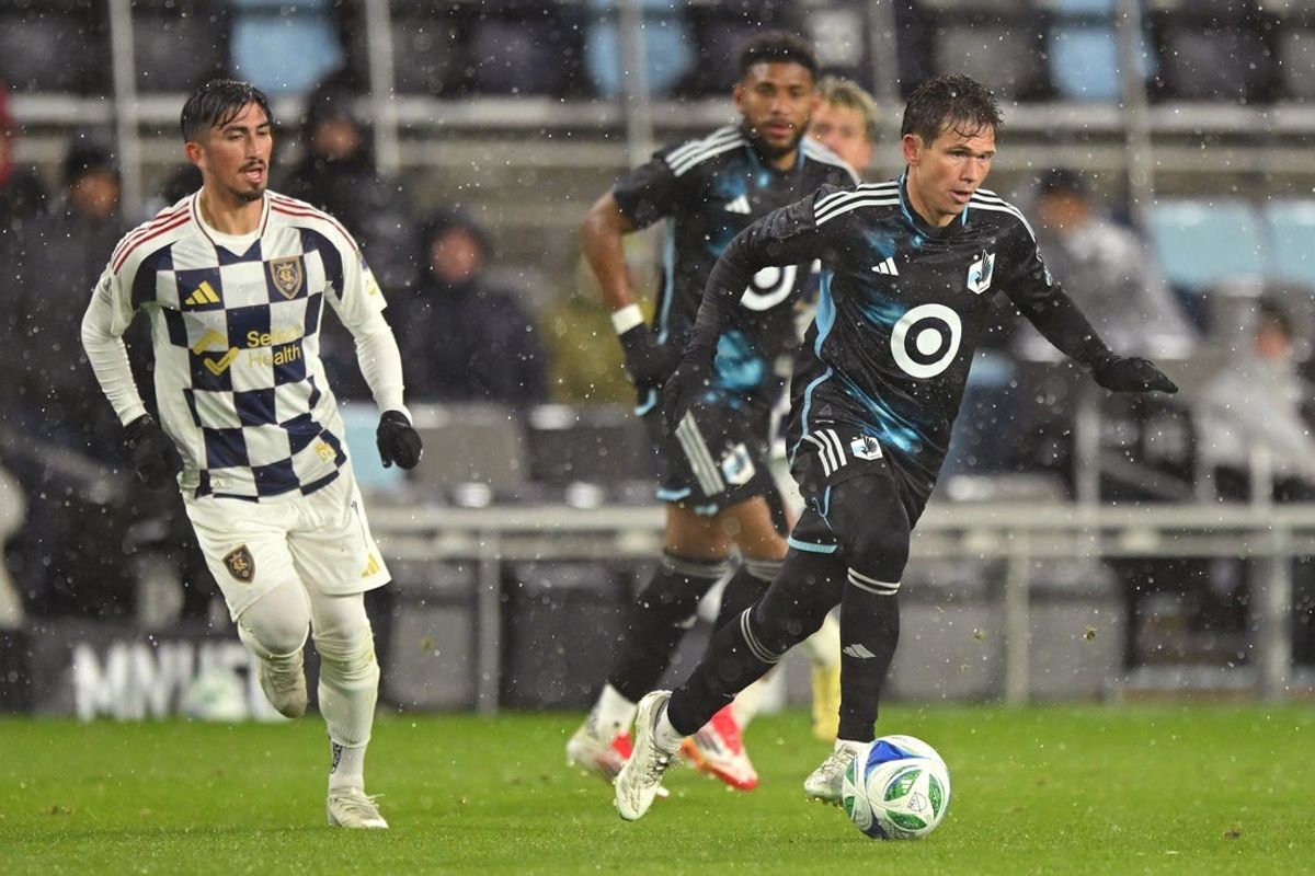 Mar 29, 2025; Saint Paul, Minnesota, USA;  Minnesota United midfielder Wil Trapp (20) controls the ball as Real Salt Lake midfielder Pablo Ruiz (7) gives chase during the second half at Allianz Field. Mandatory Credit: Nick Wosika-Imagn Images