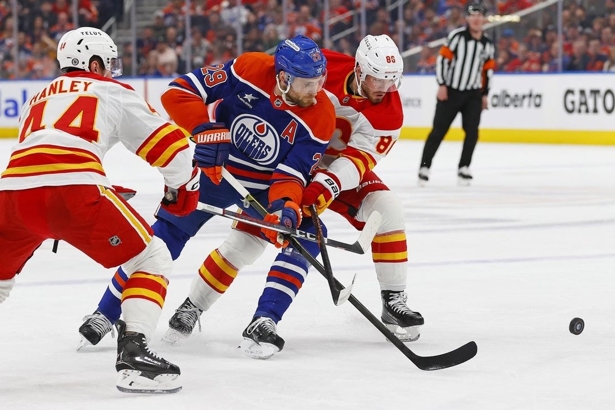 Mar 29, 2025; Edmonton, Alberta, CAN; Edmonton Oilers forward Leon Draisaitl (29) and Calgary Flames forward Joel Farabee (86) battle for a loose puck during the first period at Rogers Place. Mandatory Credit: Perry Nelson-Imagn Images