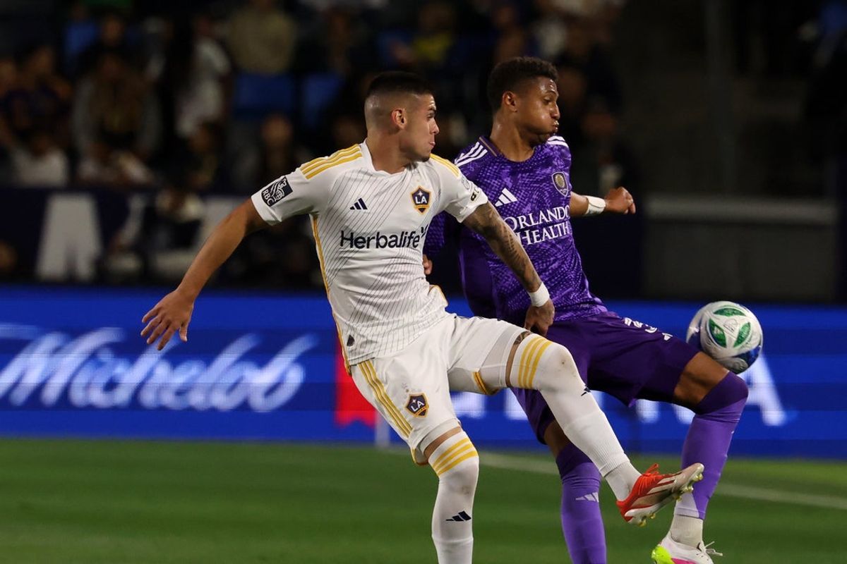 Mar 29, 2025; Carson, California, USA;  Orlando City defender Rafael Santos (3) fights for the ball against LA Galaxy forward Gabriel Pec (11) during the first half at Dignity Health Sports Park. Mandatory Credit: Kiyoshi Mio-Imagn Images