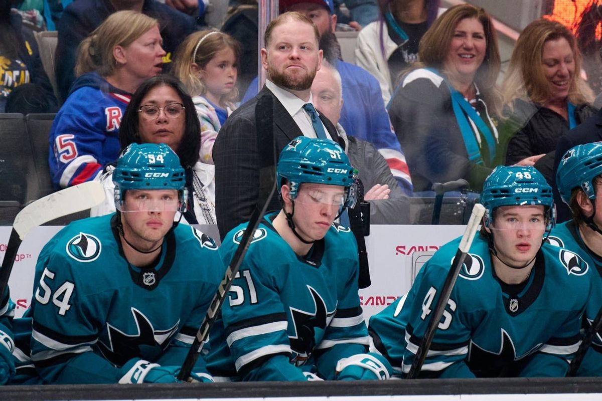 Mar 29, 2025; San Jose, California, USA; San Jose Sharks head coach Ryan Warsofsky, right wing Patrick Giles (54), right wing Collin Graf (51) and center Cam Lund (46) watch the play against the New York Rangers during the third period at SAP Center at San Jose. Mandatory Credit: Robert Edwards-Imagn Images
