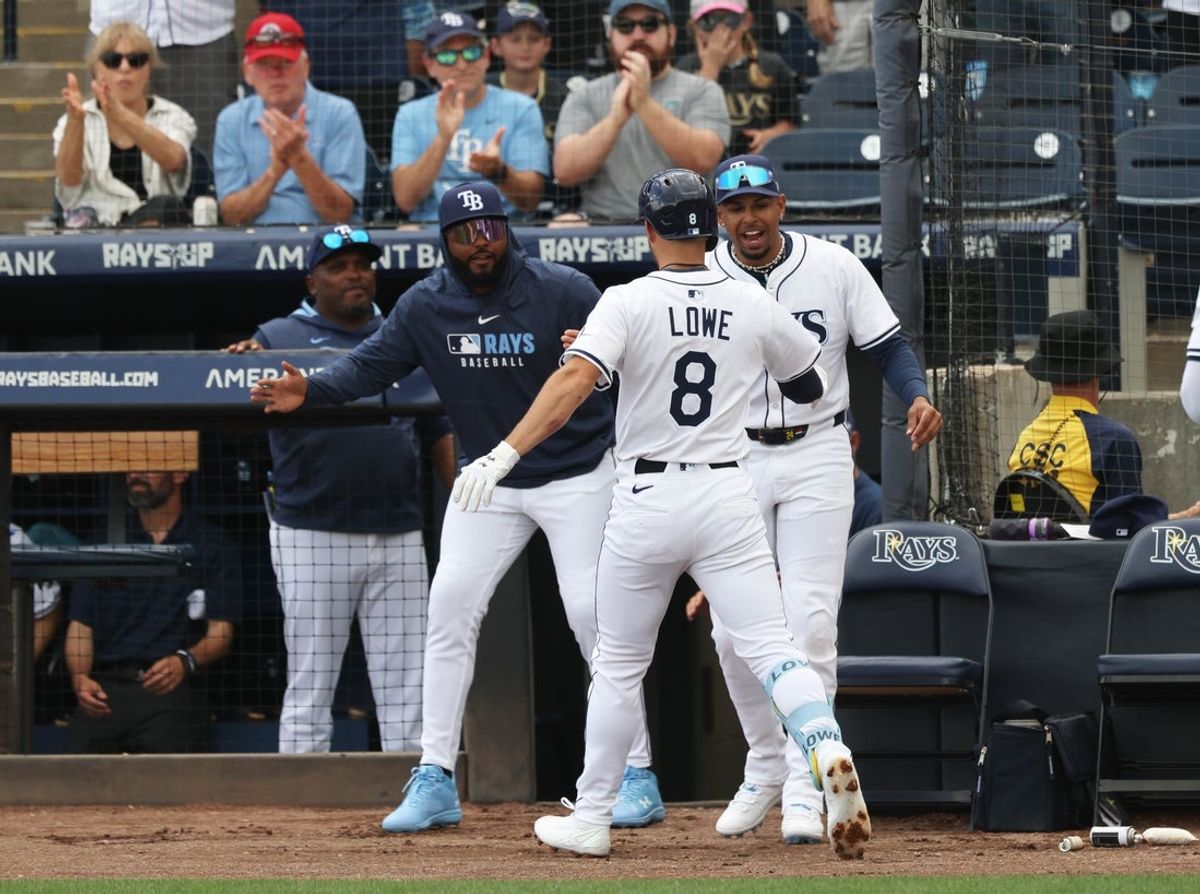 Mar 30, 2025; Tampa, Florida, USA; Tampa Bay Rays second base Brandon Lowe (8) is congratulated by left fielder Christopher Morel (24) and third base Junior Caminero (13) after he hit a 2-run home run against the Colorado Rockies during the first inning at George M. Steinbrenner Field. Mandatory Credit: Kim Klement Neitzel-Imagn Images