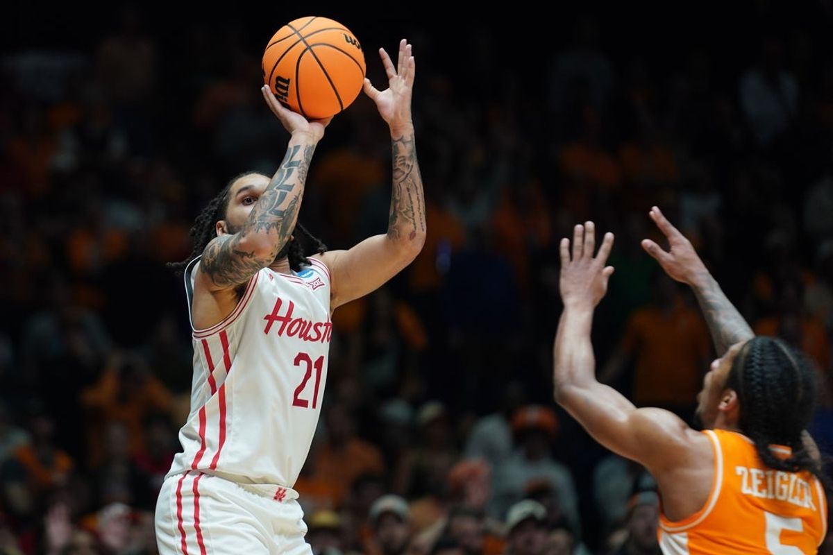 Mar 30, 2025; Indianapolis, IN, USA; Houston Cougars guard Emanuel Sharp (21) shoots the ball past Tennessee Volunteers guard Zakai Zeigler (5) in the second half during the Midwest Regional final of the 2025 NCAA tournament at Lucas Oil Stadium. Mandatory Credit: Robert Goddin-Imagn Images