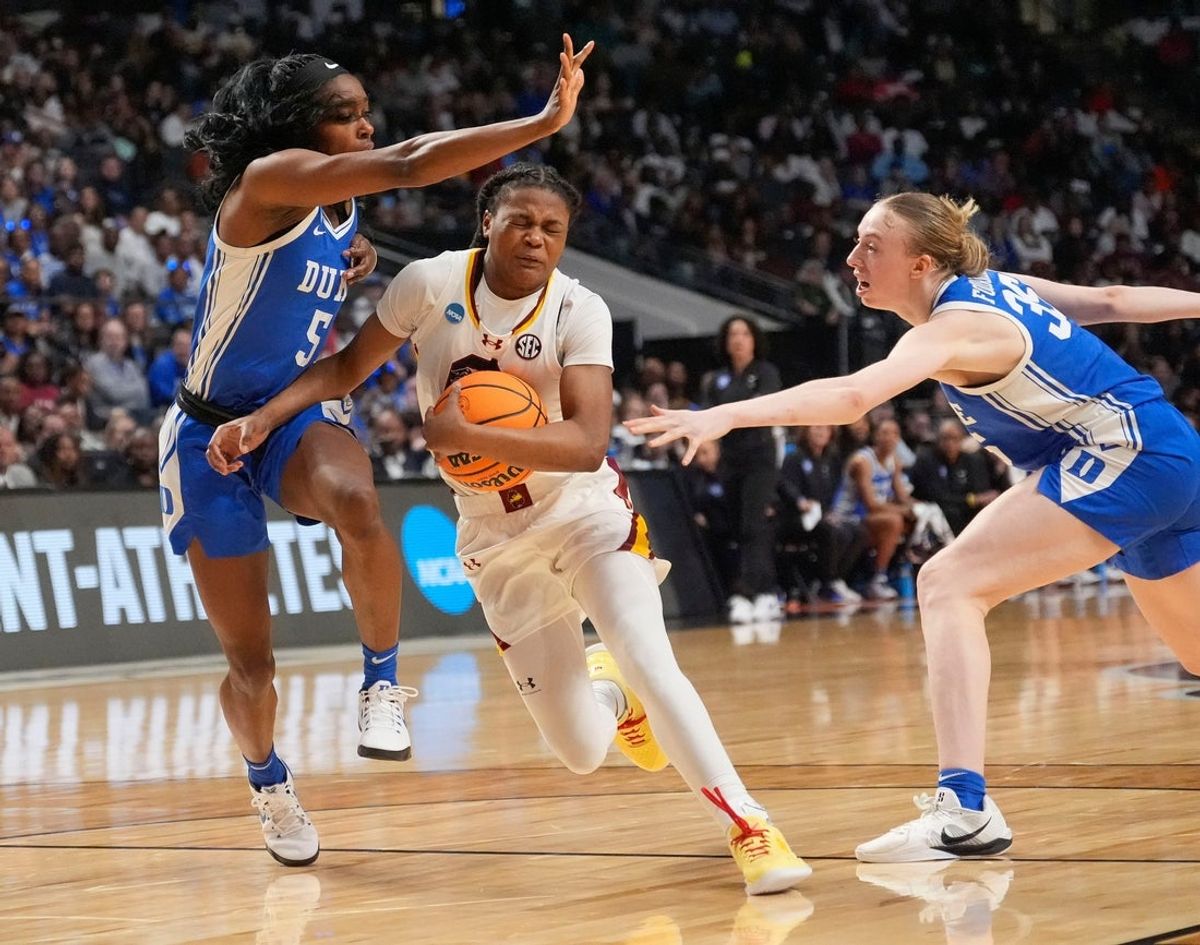 Mar 30, 2025; Birmingham, AL, USA; South Carolina Gamecocks guard MiLaysia Fulwiley (12) slices between Duke Blue Devils guard Oluchi Okananwa (5) and Duke Blue Devils forward Toby Fournier (35) as she attempts a drive into the lane at Legacy Arena. South Carolina defeated Duke 54-50 to advance to the Final Four. Mandatory Credit: Gary Cosby Jr.-Tuscaloosa News