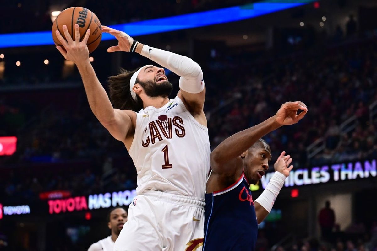 Mar 30, 2025; Cleveland, Ohio, USA; Cleveland Cavaliers guard Max Strus (1) drives to the basket against Los Angeles Clippers guard Kris Dunn (8) during the first half at Rocket Arena. Mandatory Credit: Ken Blaze-Imagn Images