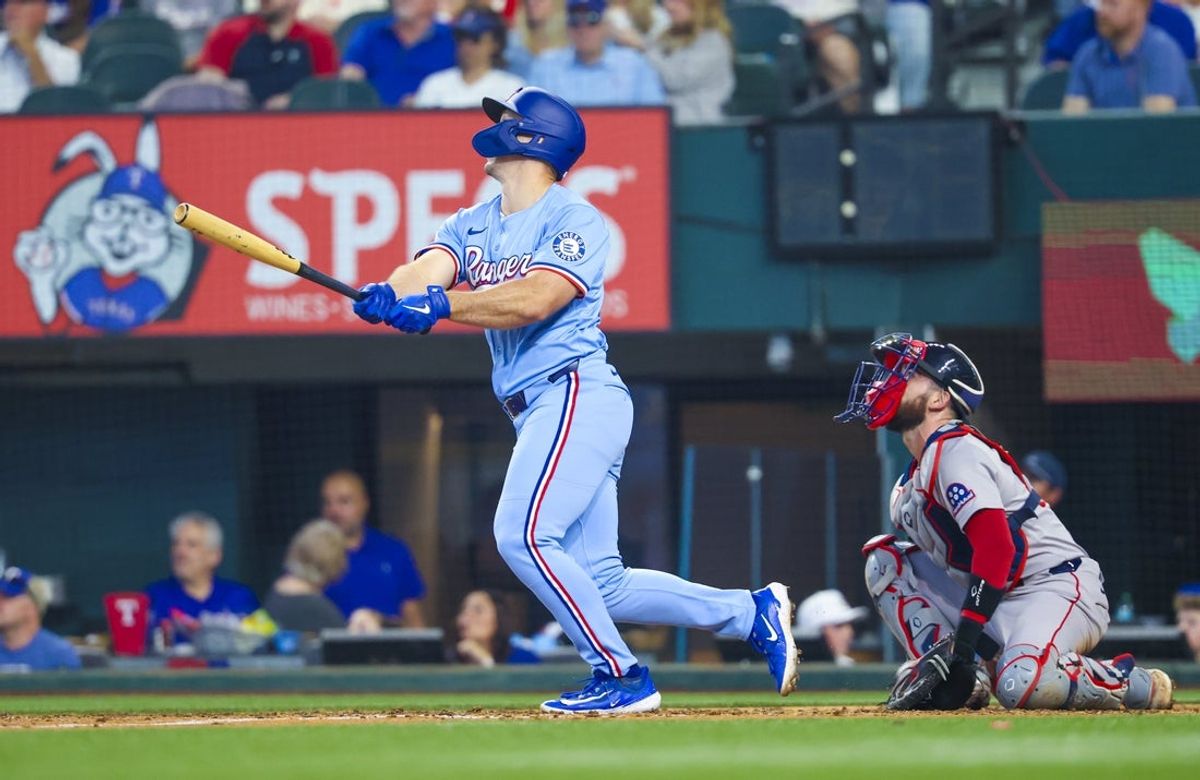 Mar 30, 2025; Arlington, Texas, USA; Texas Rangers left fielder Wyatt Langford (36) hits a home run during the sixth inning against the Boston Red Sox at Globe Life Field. Mandatory Credit: Kevin Jairaj-Imagn Images