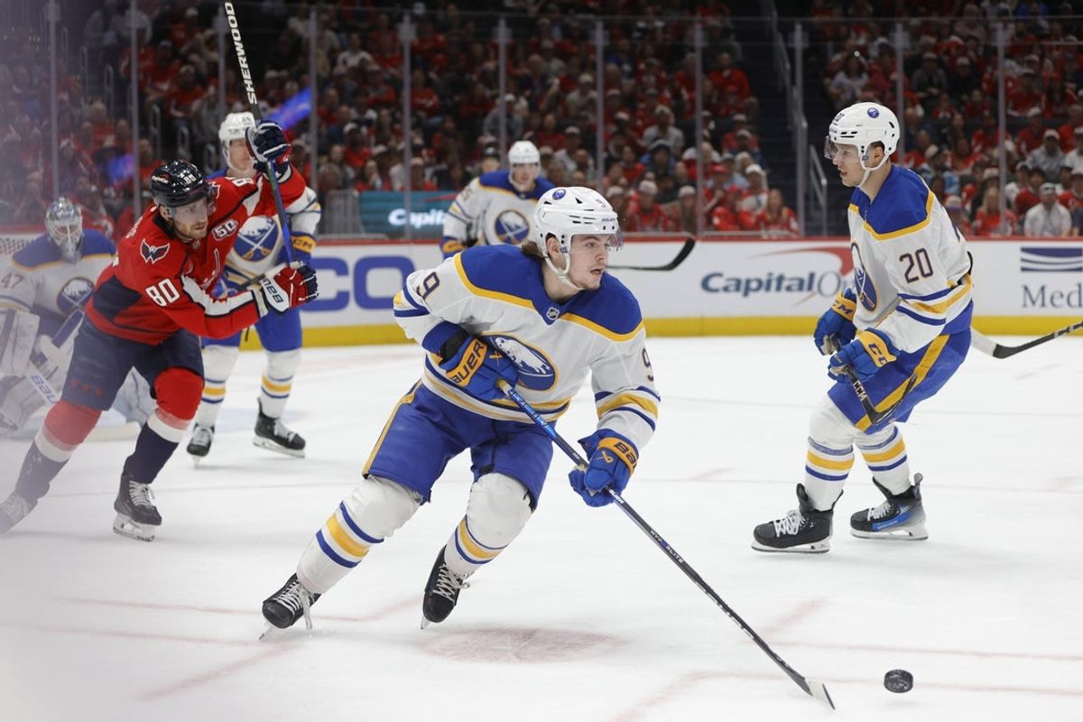 Mar 29, 2025; Washington, District of Columbia, USA; Buffalo Sabres left wing Zach Benson (9) skates with the puck past Washington Capitals left wing Pierre-Luc Dubois (80) during the second half at Audi Field. Mandatory Credit: Amber Searls-Imagn Images