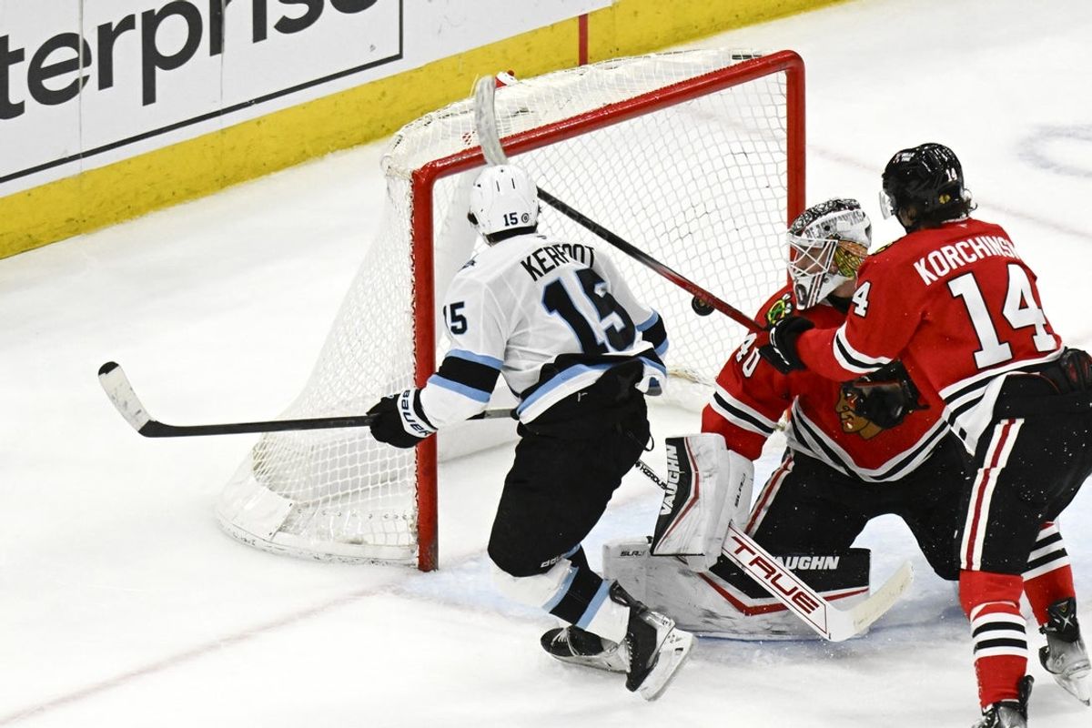 Mar 30, 2025; Chicago, Illinois, USA; Utah Hockey Club center Alexander Kerfoot (15) scores against Chicago Blackhawks goaltender Arvid Soderblom (40) during the second period at United Center. Mandatory Credit: Matt Marton-Imagn Images