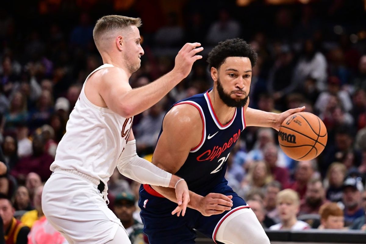 Mar 30, 2025; Cleveland, Ohio, USA; Los Angeles Clippers guard Norman Powell (24) drives to the basket against Cleveland Cavaliers guard Sam Merrill (5) during the second half at Rocket Arena. Mandatory Credit: Ken Blaze-Imagn Images