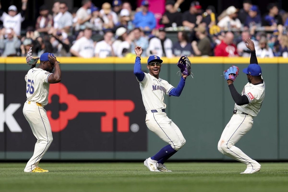 Mar 30, 2025; Seattle, Washington, USA; Seattle Mariners outfielders Randy Arozarena (56), Julio Rodriguez (44), and Victor Robles (10) celebrate after the team’s win against the Oakland Athletics at T-Mobile Park. Mandatory Credit: Ryan Sun-Imagn Images