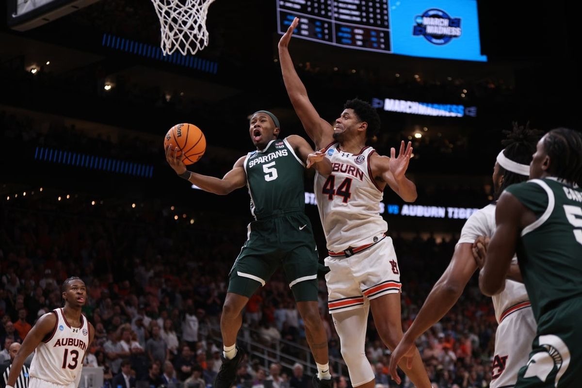 Mar 30, 2025; Atlanta, GA, USA; Michigan State Spartans guard Tre Holloman (5) shoots against Auburn Tigers center Dylan Cardwell (44) during the second half in the South Regional final of the 2025 NCAA tournament at State Farm Arena. Mandatory Credit: Brett Davis-Imagn Images