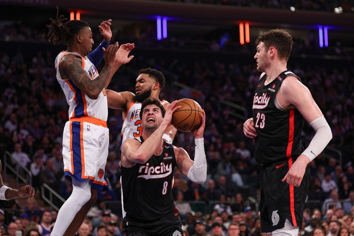 Mar 30, 2025; New York, New York, USA; Portland Trail Blazers forward Deni Avdija (8) drives to the basket against New York Knicks center Karl-Anthony Towns (32) during the first half at Madison Square Garden. Mandatory Credit: Vincent Carchietta-Imagn Images