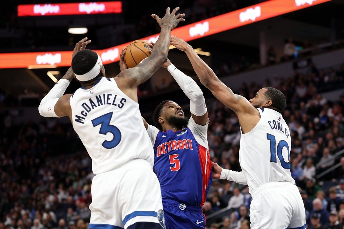 Mar 30, 2025; Minneapolis, Minnesota, USA; Detroit Pistons guard Malik Beasley (5) shoots the ball as Minnesota Timberwolves forward Jaden McDaniels (3) and guard Mike Conley (10) defend during the first quarter at Target Center. Mandatory Credit: Matt Krohn-Imagn Images