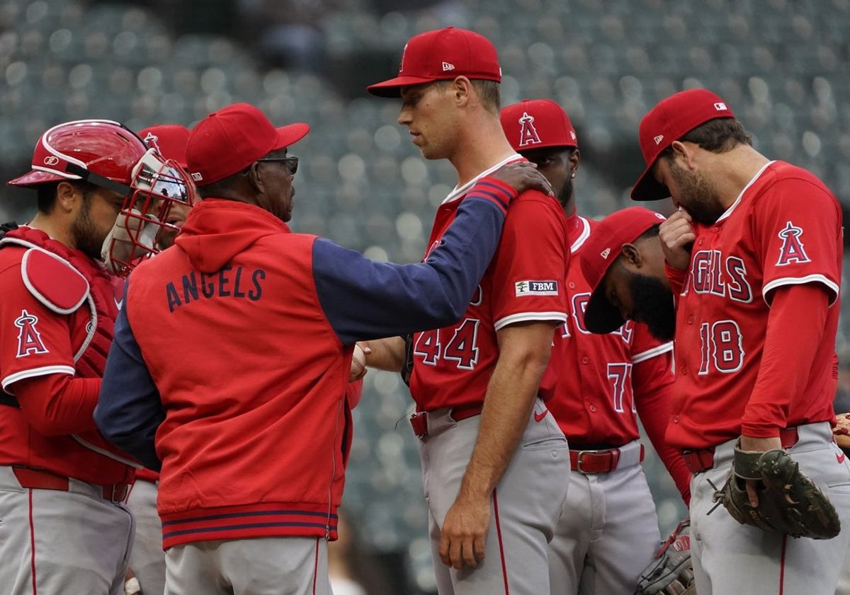 Mar 30, 2025; Chicago, Illinois, USA; Los Angeles Angels manager Ron Washington (37) talks with pitcher Ben Joyce (44) during the seventh inning against the Chicago White Sox at Guaranteed Rate Field. Mandatory Credit: David Banks-Imagn Images