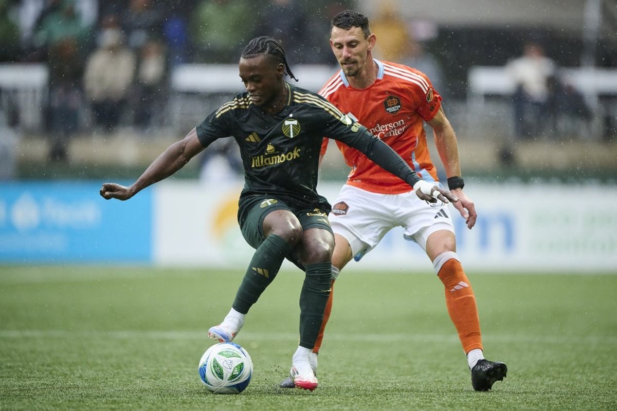Mar 30, 2025; Portland, Oregon, USA; Portland Timbers midfielder Santiago Moreno (30) controls a pass during the first half against Houston Dynamo defender Daniel Steres (5) at Providence Park. Mandatory Credit: Troy Wayrynen-Imagn Images