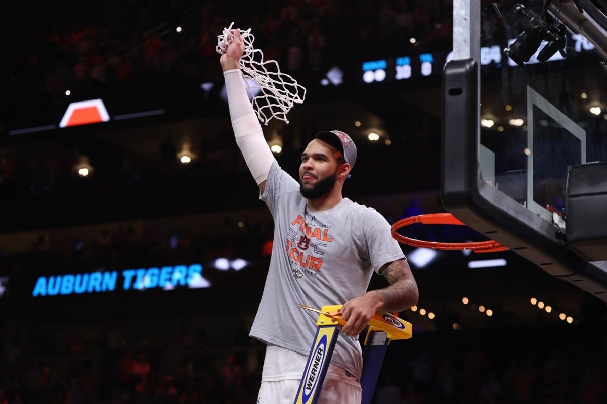Mar 30, 2025; Atlanta, GA, USA; Auburn Tigers forward Johni Broome (4) cuts down the net after winning the South Regional final of the 2025 NCAA tournament against the Michigan State Spartans at State Farm Arena. Mandatory Credit: Brett Davis-Imagn Images