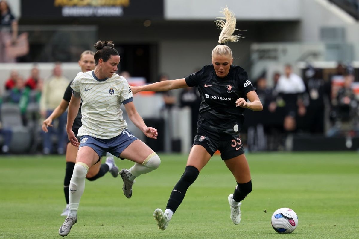 Mar 30, 2025; Los Angeles, California, USA;  Seattle Reign FC defender Phoebe McClernon (21) and Angel City FC forward Riley Tiernan (33) fight for the ball during the first half at BMO Stadium. Mandatory Credit: Kiyoshi Mio-Imagn Images