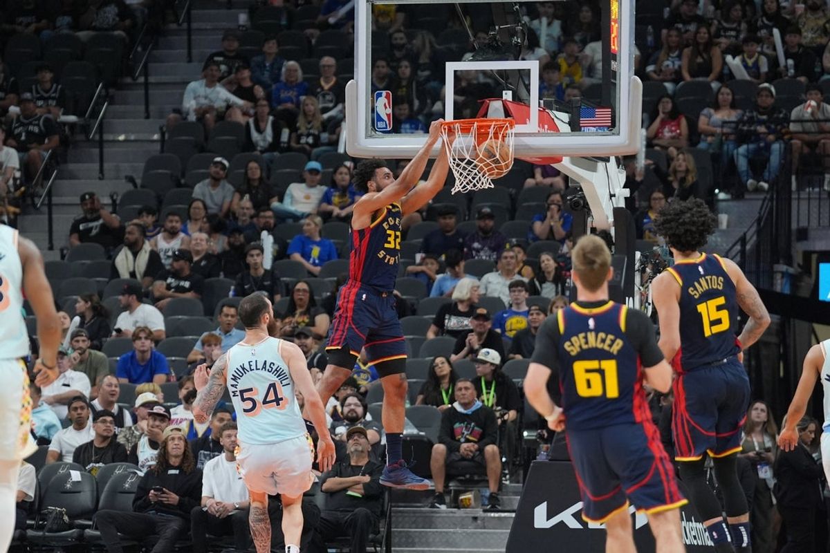 Mar 30, 2025; San Antonio, Texas, USA;  Golden State Warriors forward Trayce Jackson-Davis (32) dunks the ball in front of San Antonio Spurs forward Sandro Mamukelashvili (54) in the second half at Frost Bank Center. Mandatory Credit: Daniel Dunn-Imagn Images