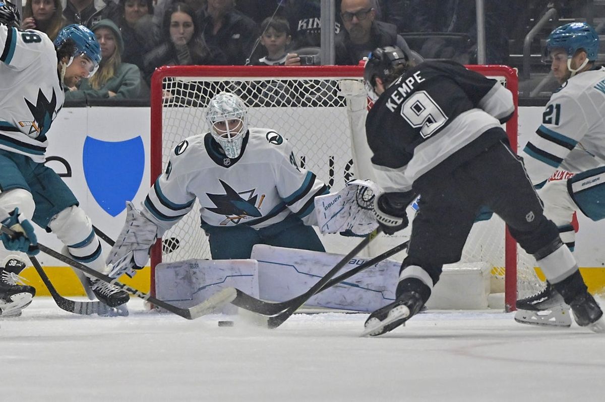 Mar 30, 2025; Los Angeles, California, USA;  Los Angeles Kings right wing Adrian Kempe (9) shoots the puck past San Jose Sharks goaltender Georgi Romanov (31) for a goal in the first period at Crypto.com Arena. Mandatory Credit: Jayne Kamin-Oncea-Imagn Images