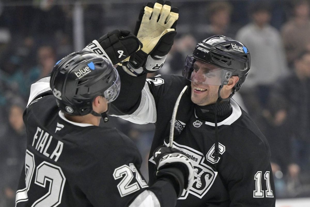 Mar 30, 2025; Los Angeles, California, USA;  Los Angeles Kings center Anze Kopitar (11) and left wing Kevin Fiala (22) high five after defeating the San Jose Sharks at Crypto.com Arena. Mandatory Credit: Jayne Kamin-Oncea-Imagn Images