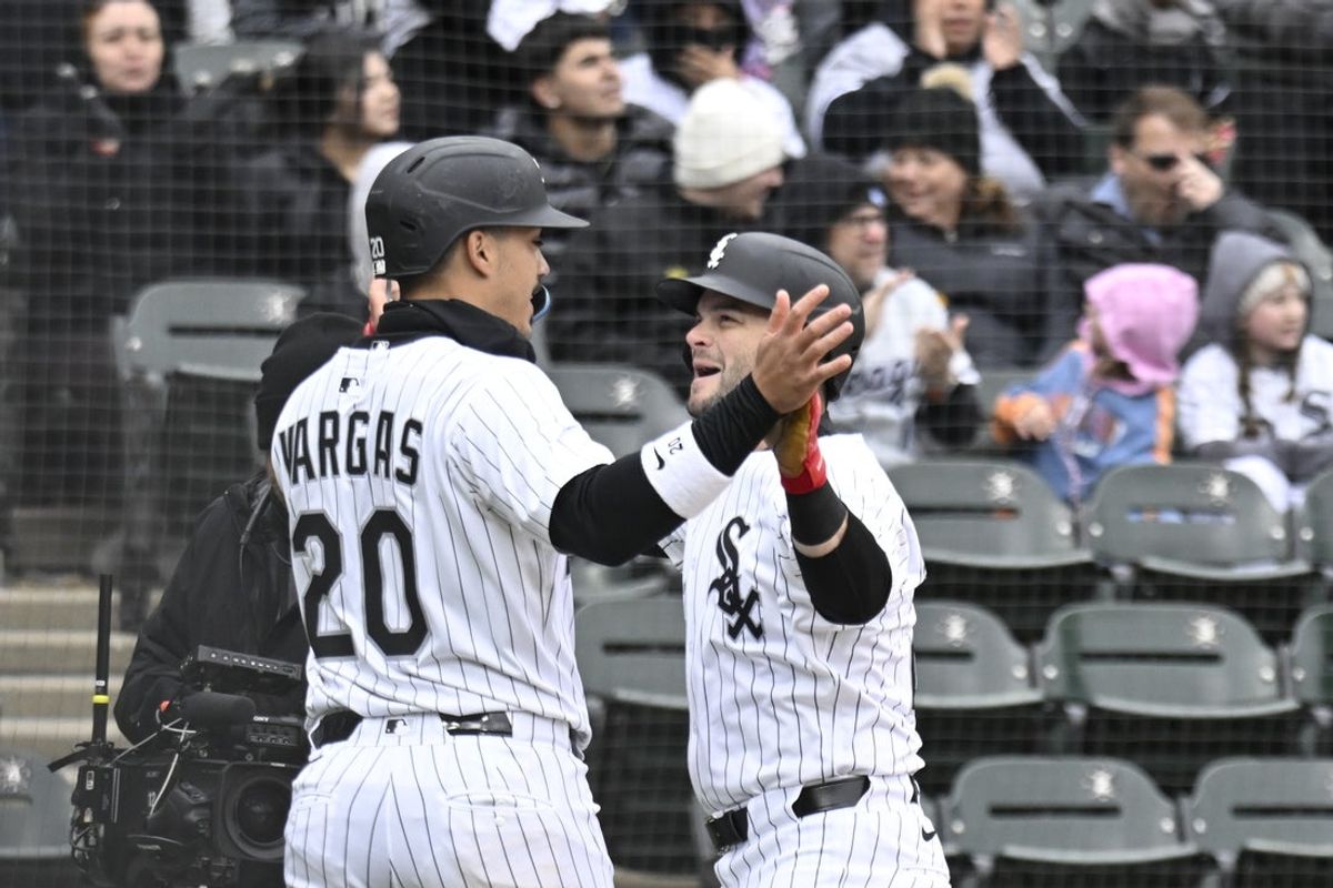 Mar 31, 2025; Chicago, Illinois, USA;  Chicago White Sox outfielder Andrew Benintendi (23) high fives   third baseman Miguel Vargas (20)  after hitting a three run home run during the second inning against the Minnesota Twins at Guaranteed Rate Field. Mandatory Credit: Matt Marton-Imagn Images