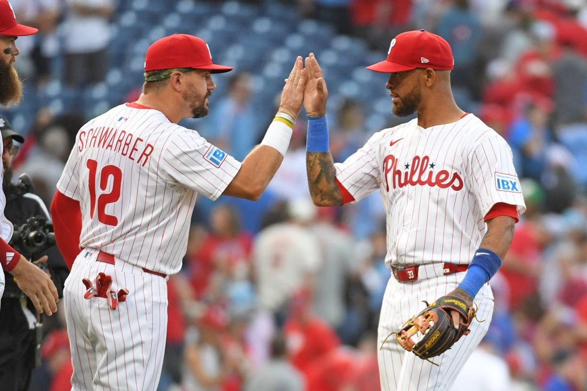 Mar 31, 2025; Philadelphia, Pennsylvania, USA; Philadelphia Phillies designated hitter Kyle Schwarber (12) and shortstop Edmundo Sosa (33) celebrate win against the Colorado Rockies at Citizens Bank Park. Mandatory Credit: Eric Hartline-Imagn Images